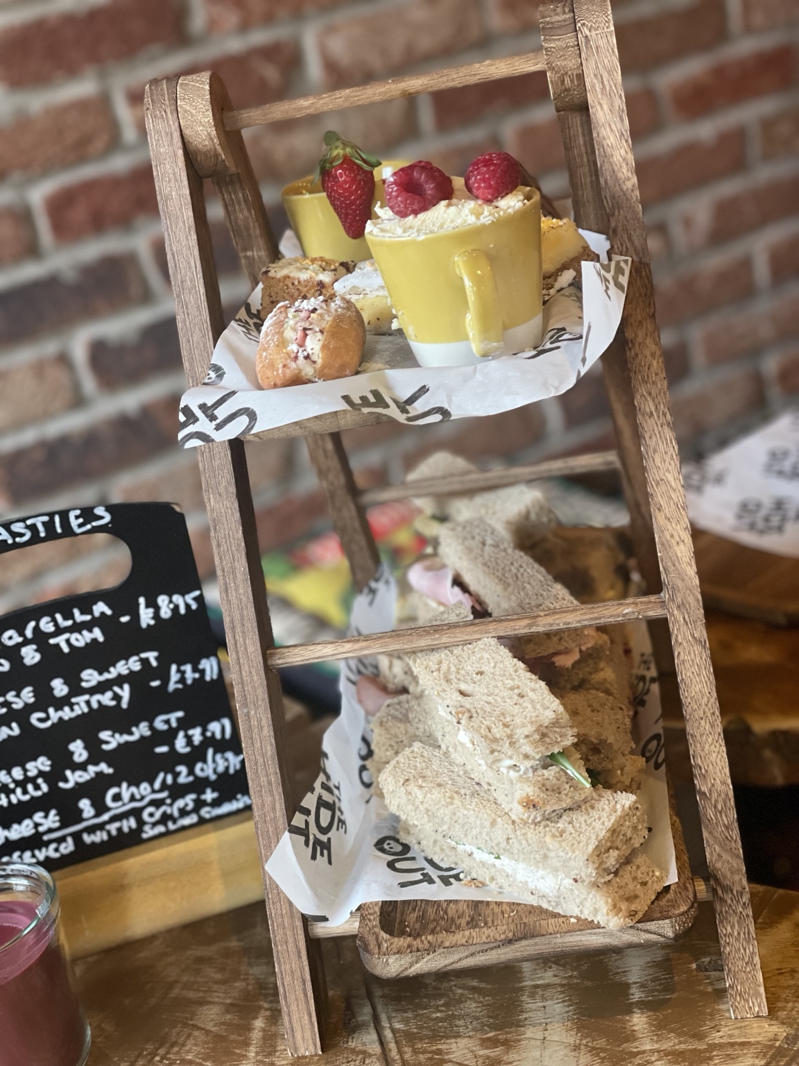 The Hideout afternoon tea served on a rustic ladder stand